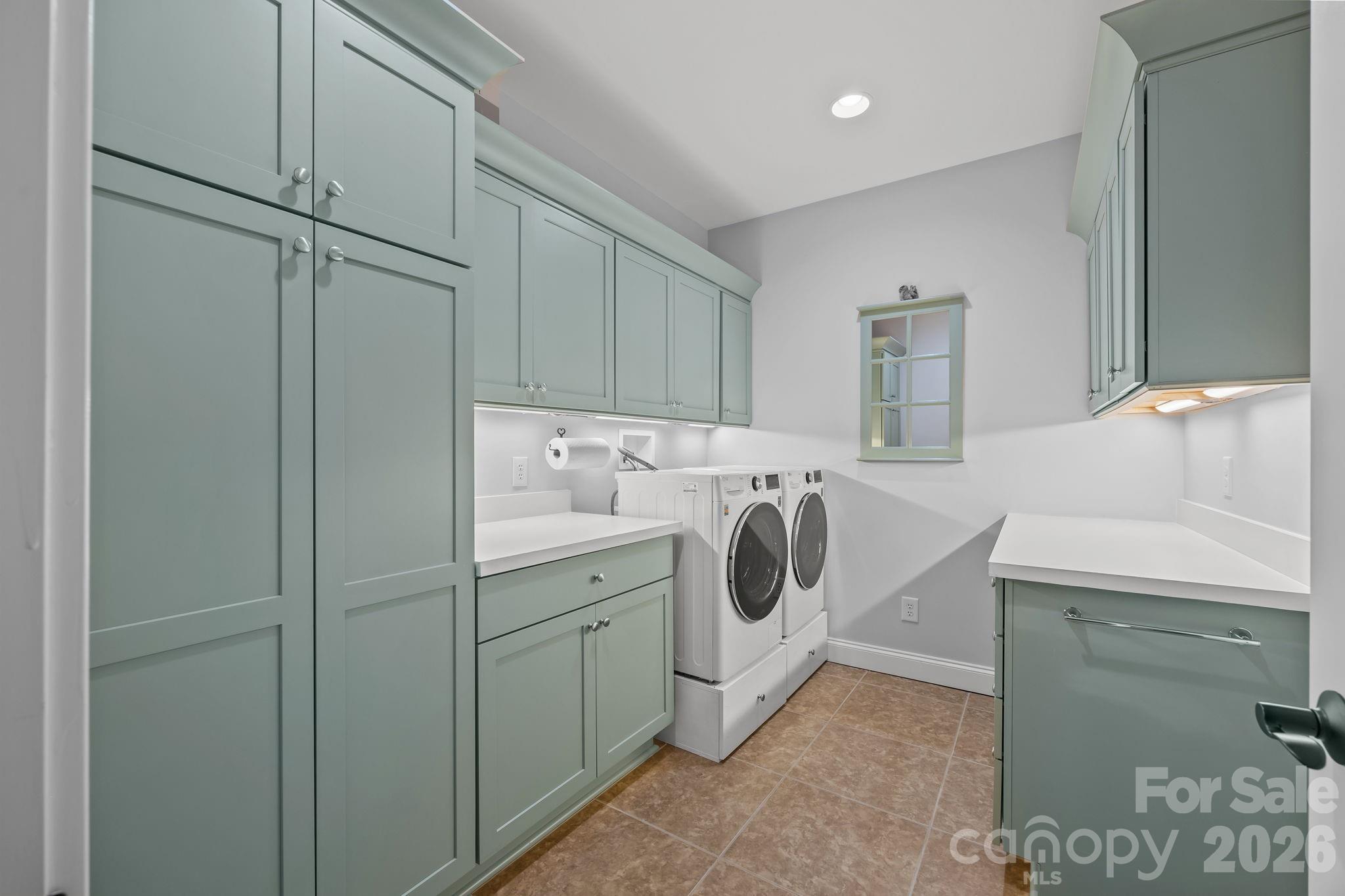242 Anniston Way Davidson, NC 28036 - Photo 30 of 42 a utility room with cabinets washer and dryer