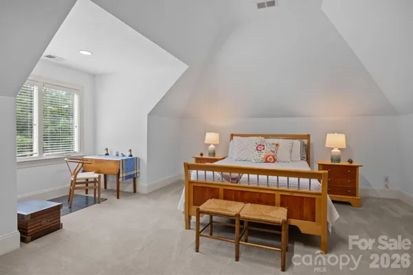a bedroom with a bed and a furniture