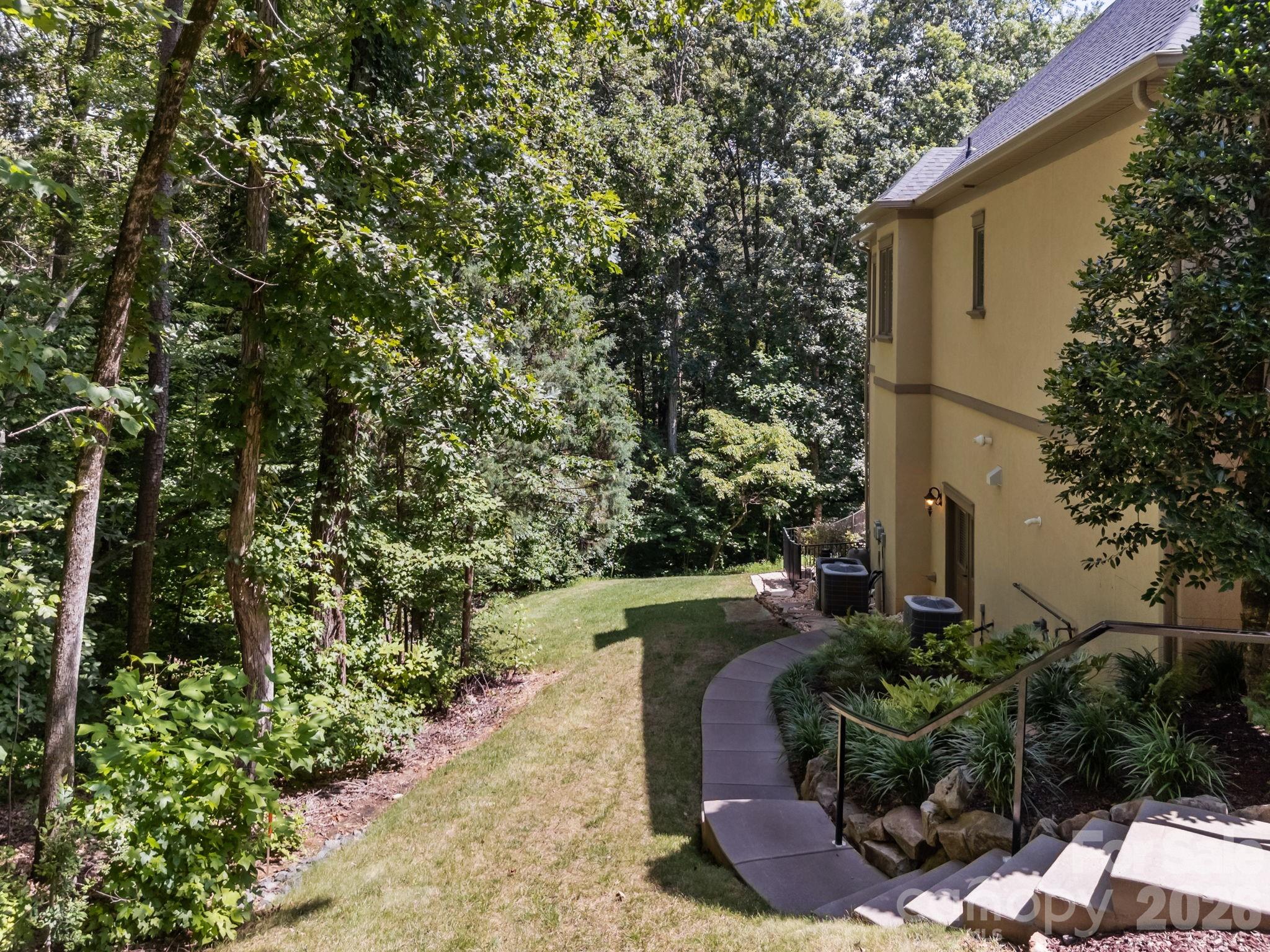 242 Anniston Way Davidson, NC 28036 - Photo 35 of 42 a view of a yard with plants and large trees