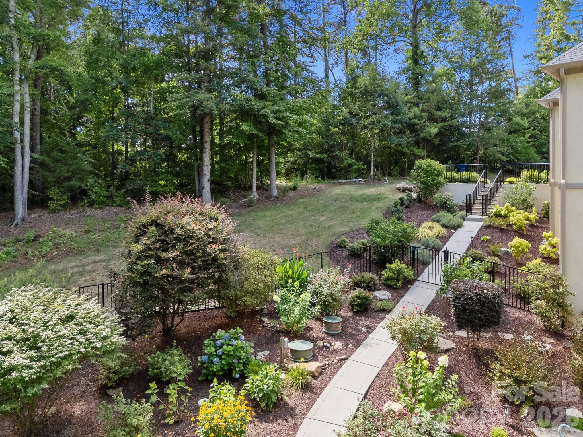 242 Anniston Way Davidson, NC 28036 - Photo 37 of 42 a view of a garden with large trees