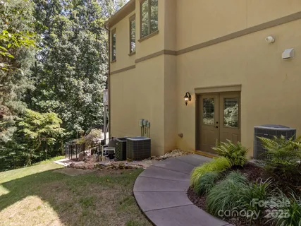 a view of a garden with large trees