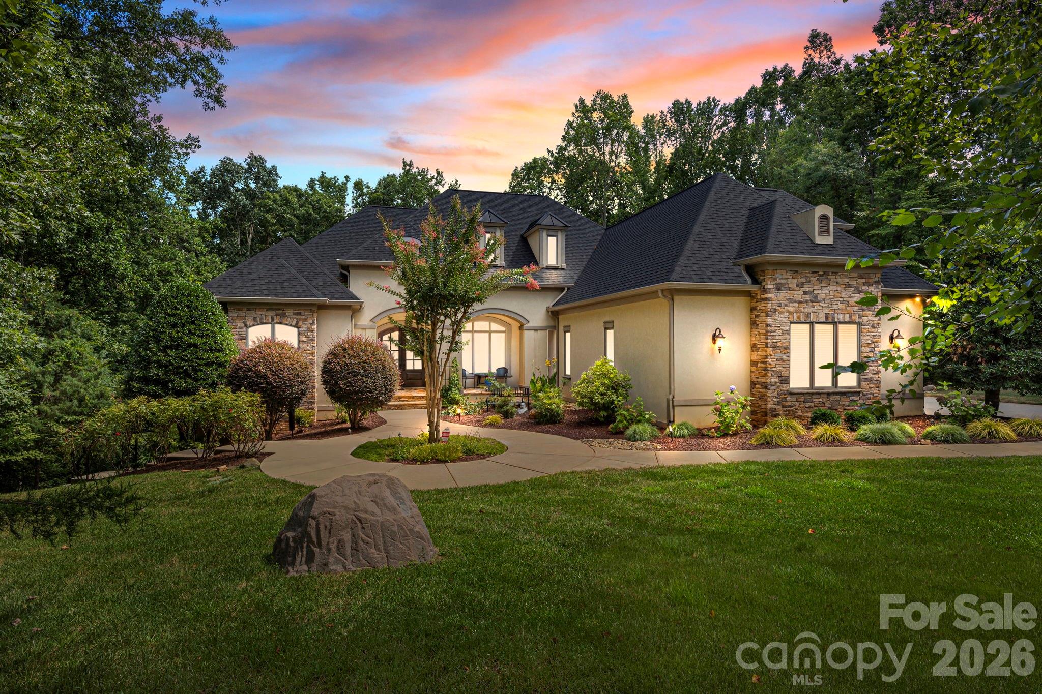 242 Anniston Way Davidson, NC 28036 - Photo 39 of 42 a front view of a house with garden and trees