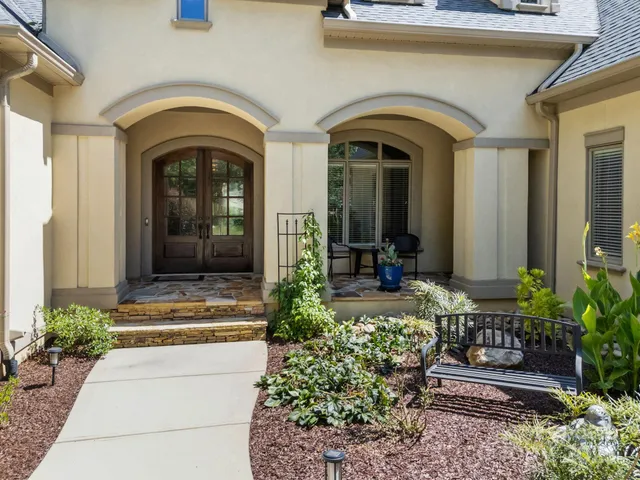 a front view of a house with garden