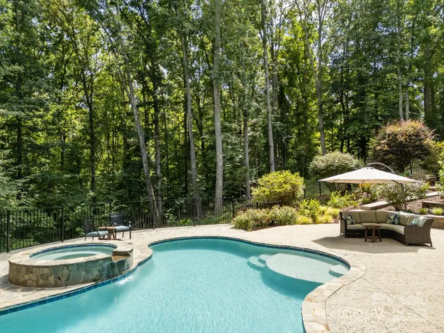 a swimming pool view with a seating space