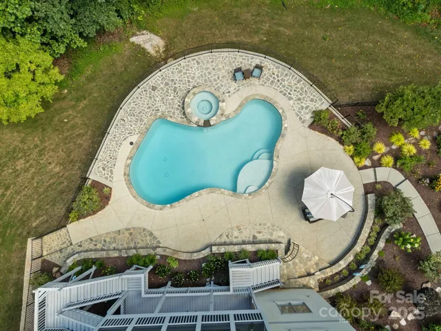 an aerial view of a swimming pool and outdoor space