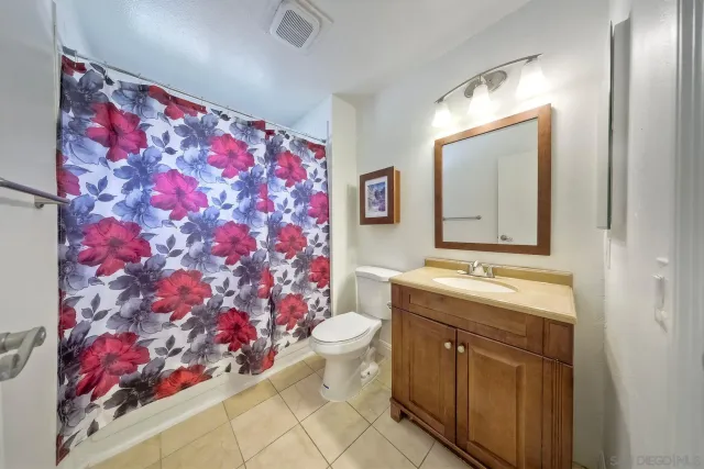 a bathroom with a sink mirror and toilet