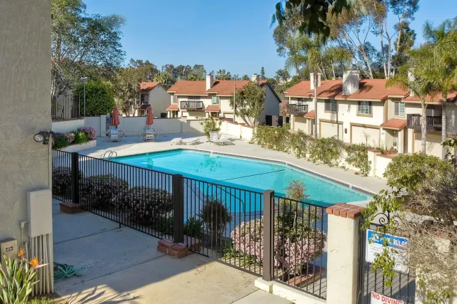 a view of a patio with a table and chairs under an umbrella