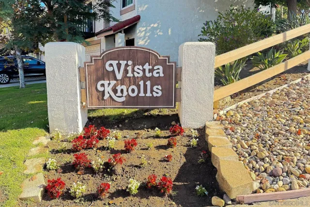 a street sign that is sitting in front of flowers