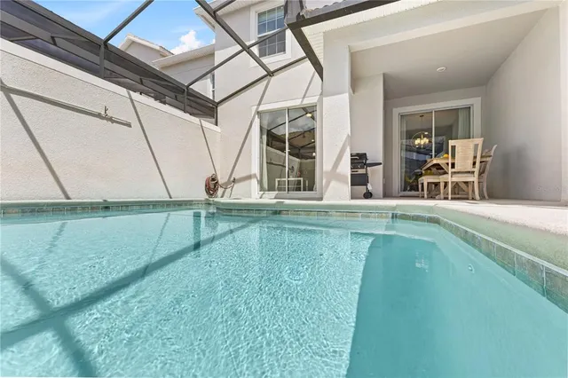 a bedroom with a bed lamp and a window