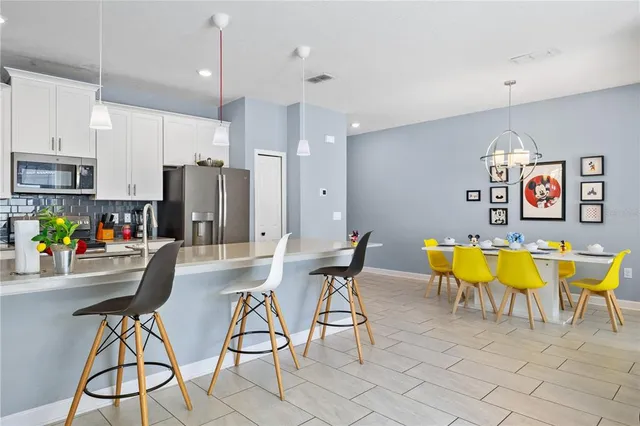 a kitchen with stainless steel appliances a sink dishwasher a microwave a sink and cabinets