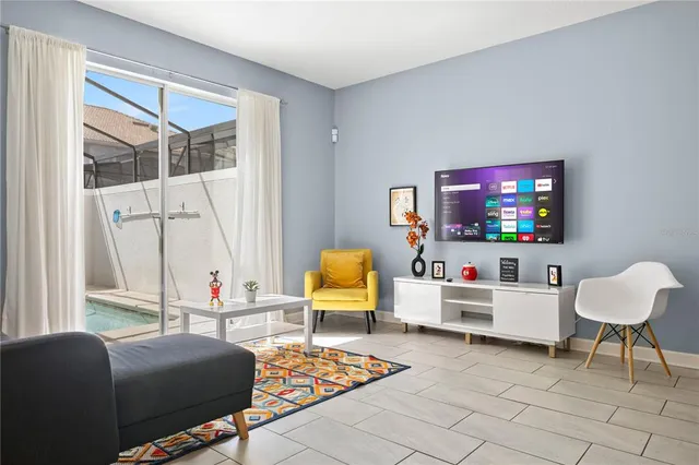 a front view of a house with a tree