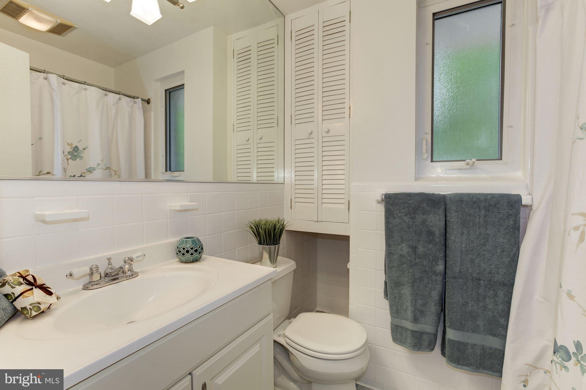 105 Belton Road Silver Spring, MD 20901 - Photo 12 of 18 a bathroom with a sink toilet and shower