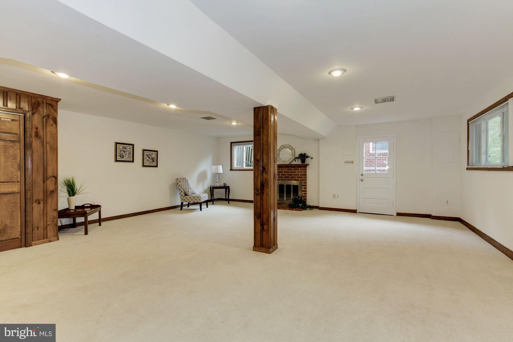 105 Belton Road Silver Spring, MD 20901 - Photo 13 of 18 an empty room with windows and couches