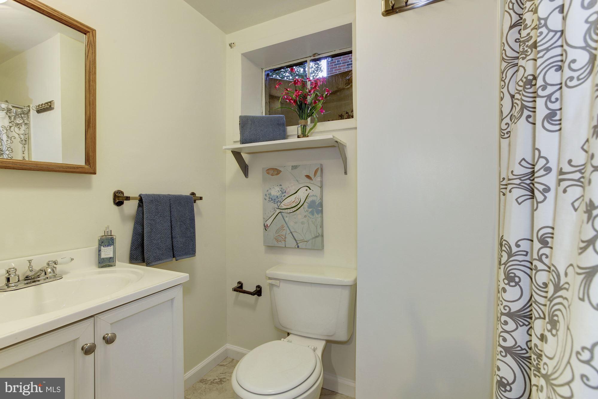 105 Belton Road Silver Spring, MD 20901 - Photo 15 of 18 a bathroom with a toilet sink and mirror