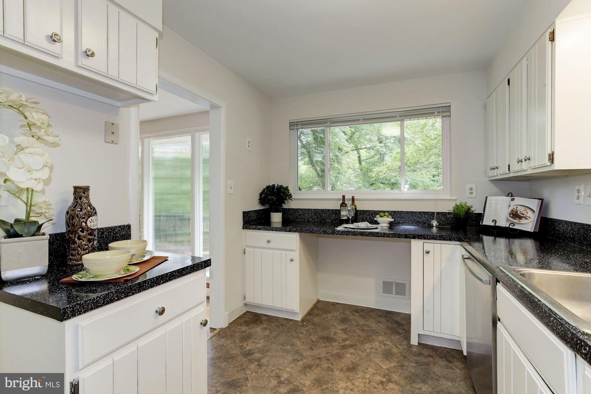 105 Belton Road Silver Spring, MD 20901 - Photo 6 of 18 a kitchen with granite countertop a sink cabinets and window
