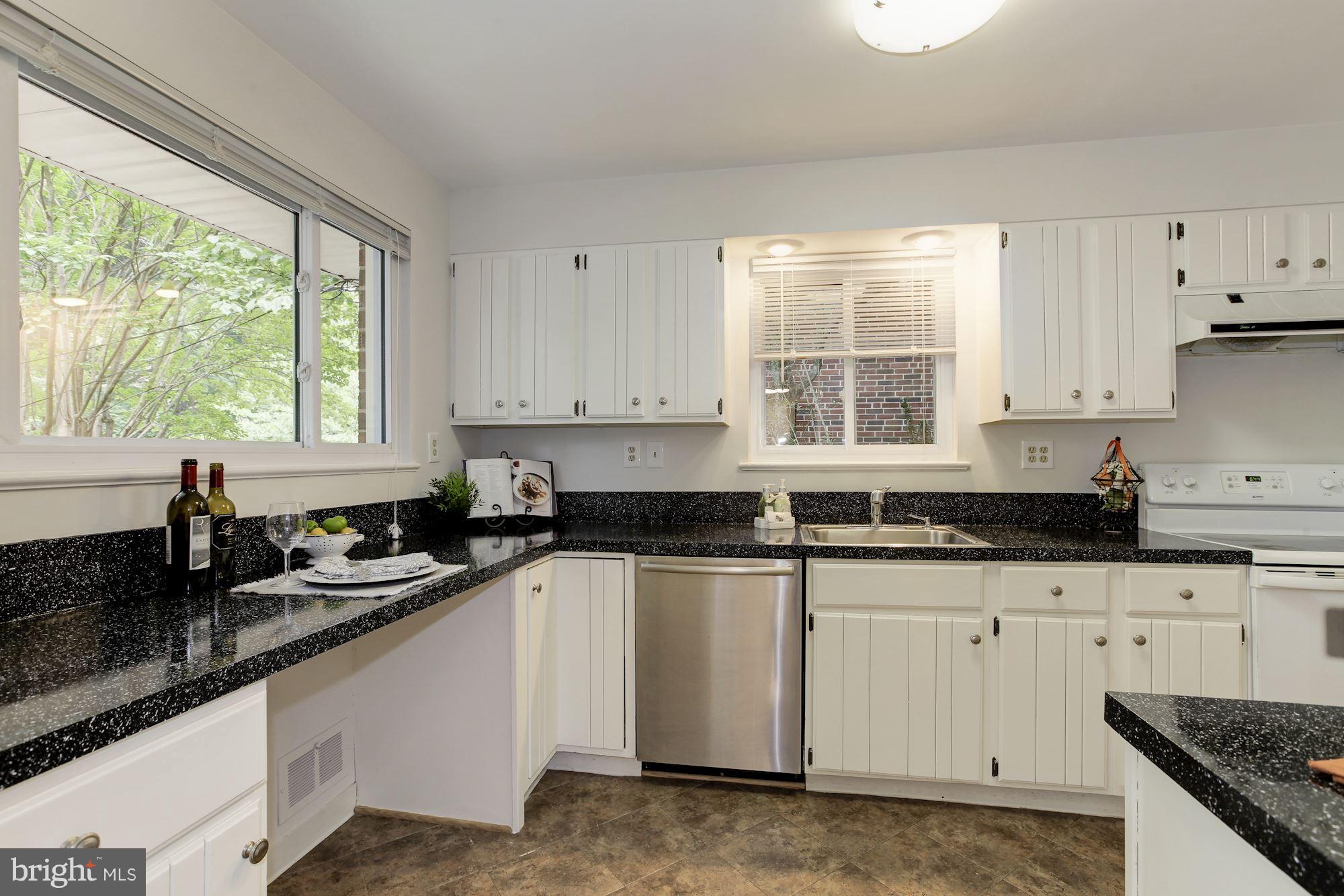 105 Belton Road Silver Spring, MD 20901 - Photo 7 of 18 a kitchen with granite countertop white cabinets and a window