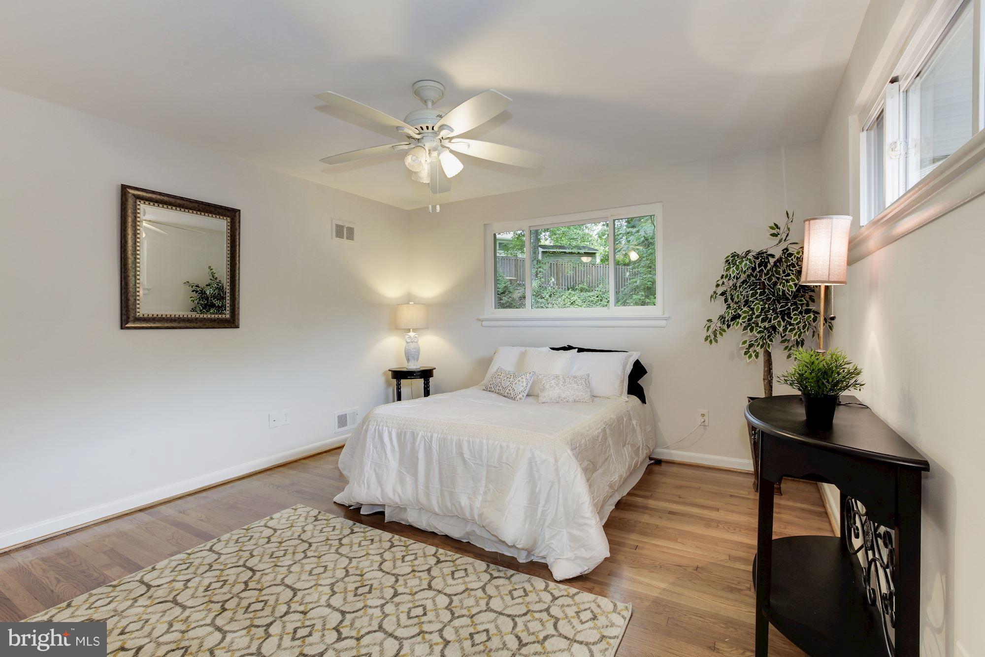 105 Belton Road Silver Spring, MD 20901 - Photo 8 of 18 a bedroom with a bed and a potted plant