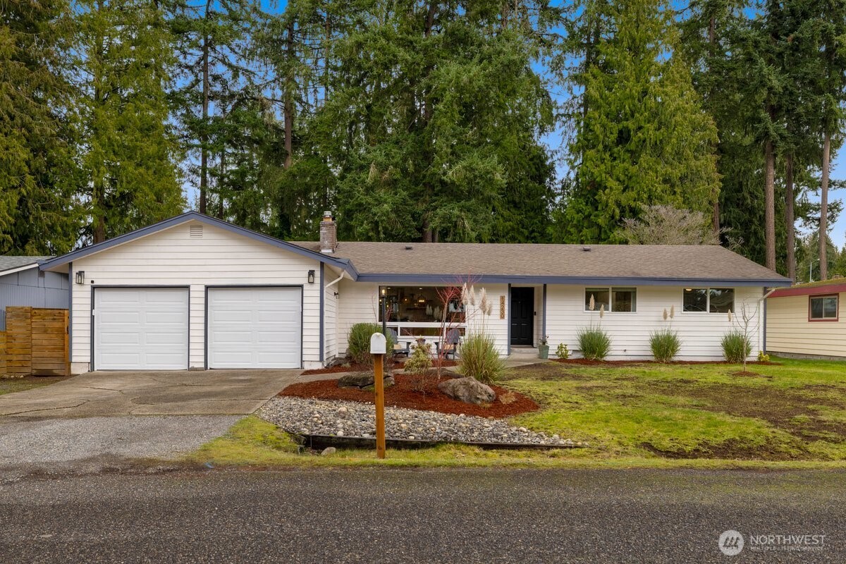 a front view of a house with a yard and garage