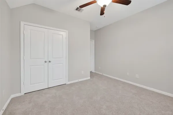 an empty room with a ceiling fan