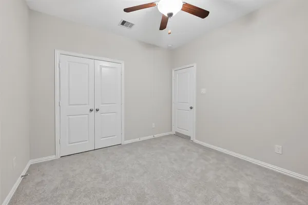an empty room with a ceiling fan