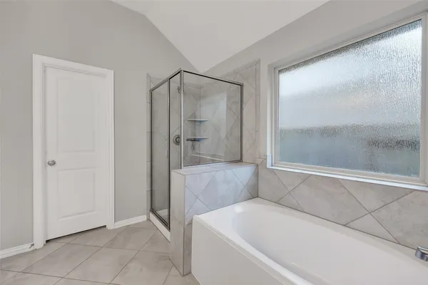 a bathroom with a bathtub and a shower