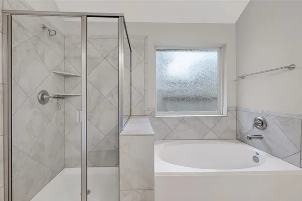 a bathroom with a shower and a bathtub
