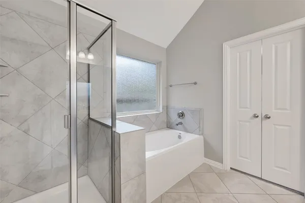a bathroom with a bathtub and shower