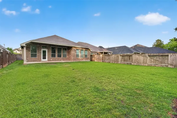 a front view of a house with a garden and yard