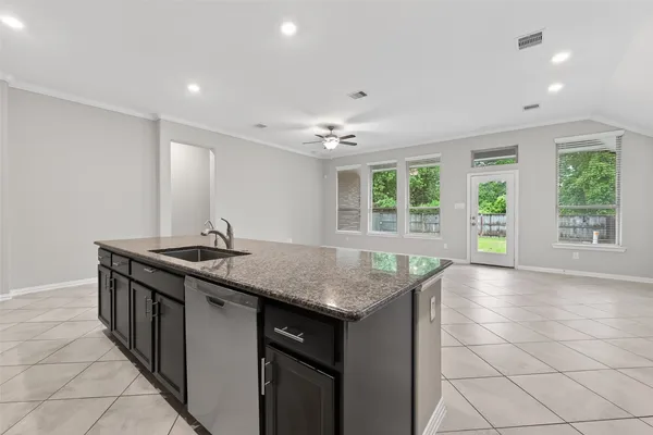 a kitchen with granite countertop a sink and a stove