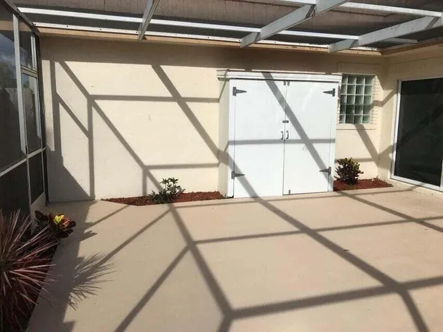 a view of a room with wooden floor and windows