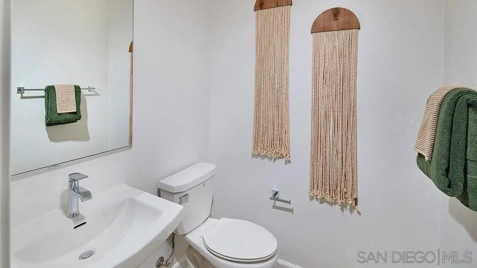 1810 Mountain Laurel Road San Marcos, CA 92078 - Photo 12 of 14 a white toilet sitting next to a bathroom sink