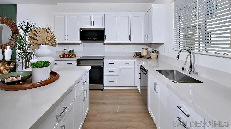 1810 Mountain Laurel Road San Marcos, CA 92078 - Photo 2 of 14 a kitchen with stainless steel appliances a sink a stove a microwave a sink a refrigerator and cabinets