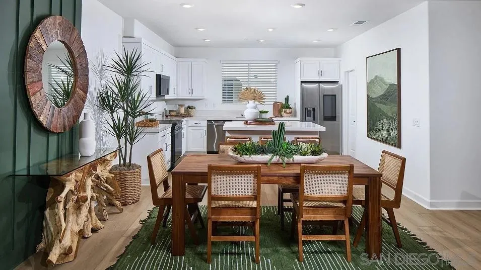 1810 Mountain Laurel Road San Marcos, CA 92078 - Photo 4 of 14 a dining room with furniture a kitchen and a chandelier