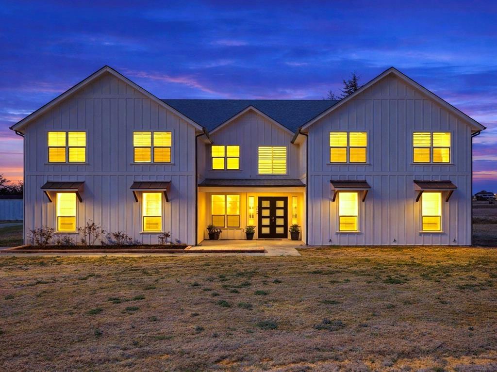 Back of house featuring french doors, board and batten siding, and a yard