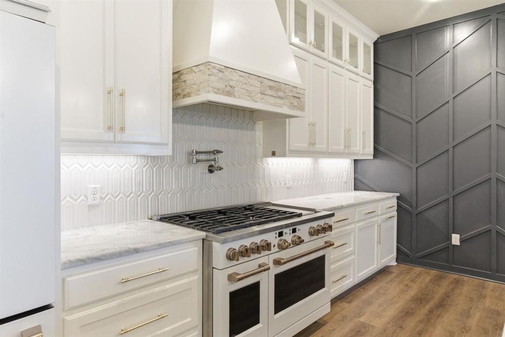 4600 Old Brock Road Weatherford, TX 76087 - Photo 12 of 40 Kitchen featuring white appliances, white cabinets, and light stone countertops