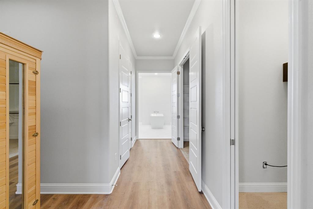 4600 Old Brock Road Weatherford, TX 76087 - Photo 19 of 40 Hallway featuring a sauna / steam room, crown molding, and light wood-type flooring