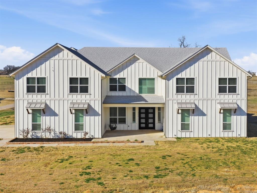4600 Old Brock Road Weatherford, TX 76087 - Photo 2 of 40 View of front of house featuring board and batten siding, a shingled roof, covered porch, a front yard, and french doors