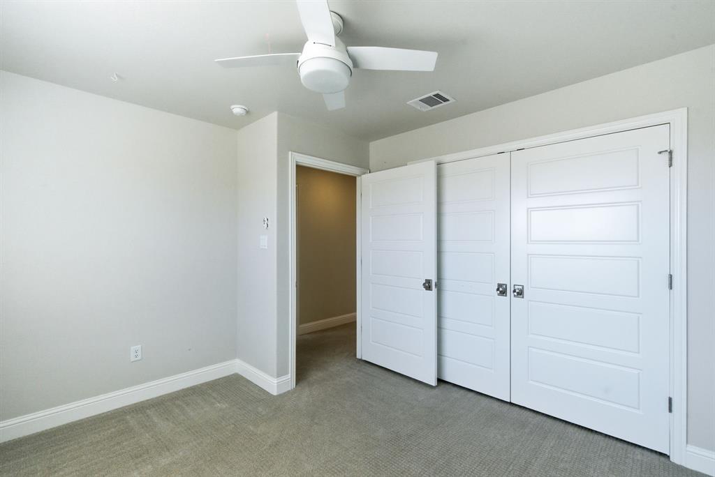 4600 Old Brock Road Weatherford, TX 76087 - Photo 34 of 40 Unfurnished bedroom featuring light carpet, a ceiling fan, and a closet
