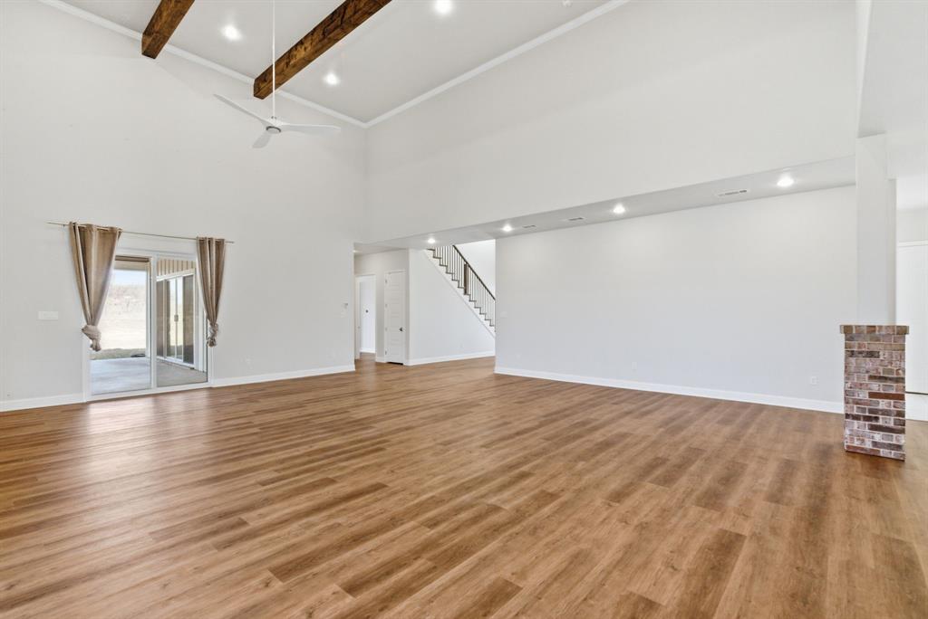 4600 Old Brock Road Weatherford, TX 76087 - Photo 9 of 40 Unfurnished living room with light wood-type flooring, a ceiling fan, and vaulted ceiling