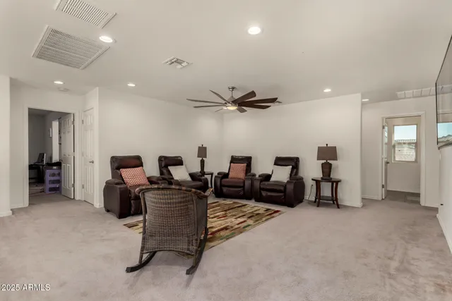 an empty room with furniture and flat screen tv