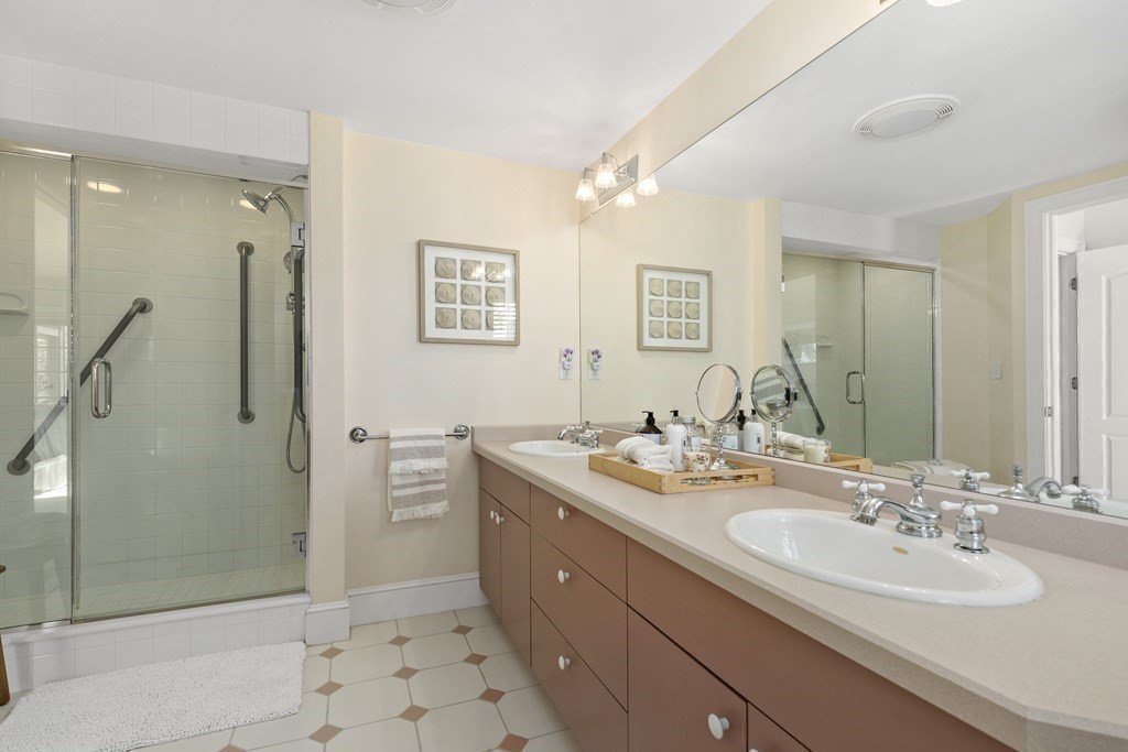 105 Parker Road, Unit A Barnstable, MA 02655 - Photo 15 of 37 a bathroom with a double vanity sink mirror and shower