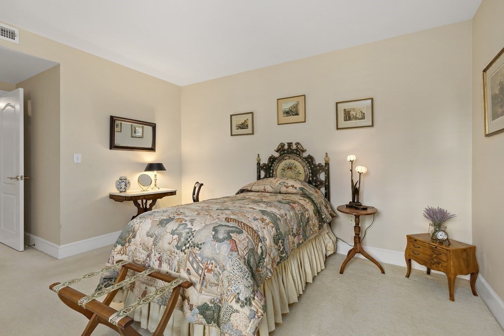 105 Parker Road, Unit A Barnstable, MA 02655 - Photo 17 of 37 a bed room with a bed and a chair