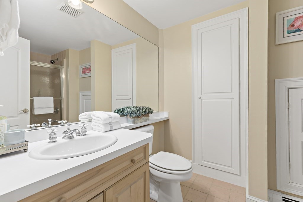 105 Parker Road, Unit A Barnstable, MA 02655 - Photo 18 of 37 a bathroom with a sink a toilet and a mirror