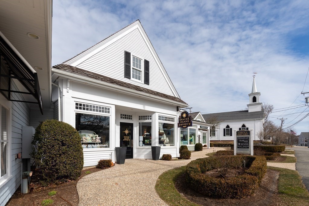 105 Parker Road, Unit A Barnstable, MA 02655 - Photo 30 of 37 a large building with a large window and potted plants