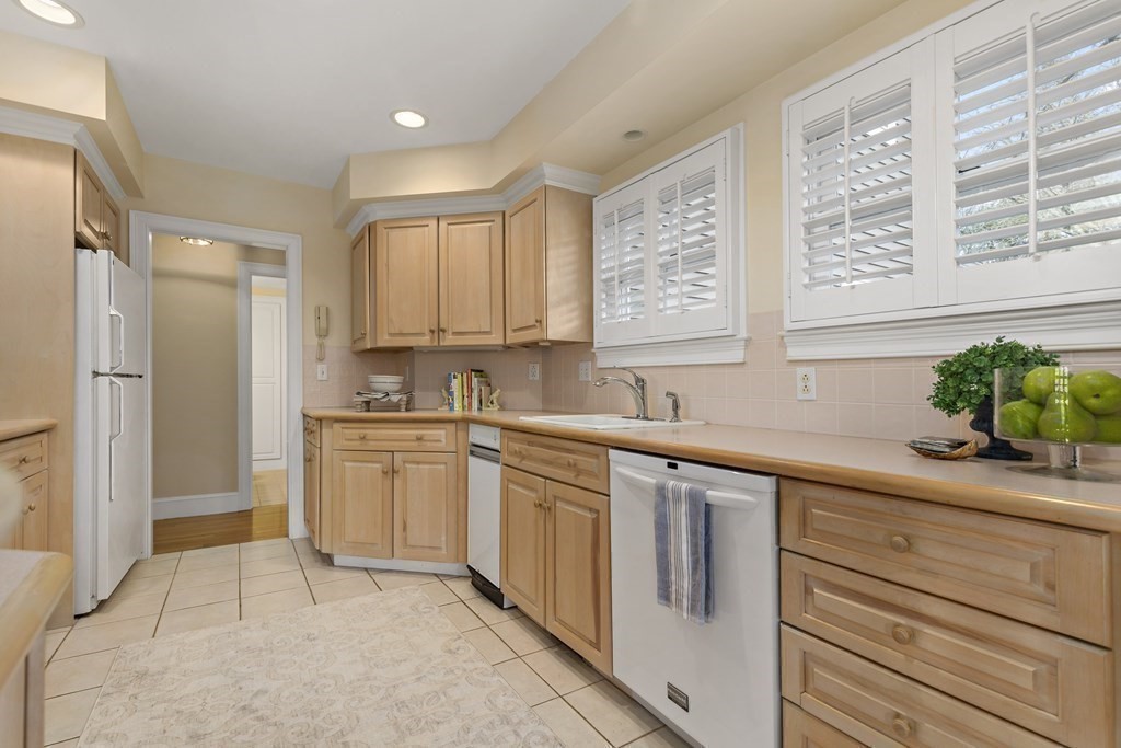 105 Parker Road, Unit A Barnstable, MA 02655 - Photo 7 of 37 a kitchen with stainless steel appliances granite countertop a sink and a refrigerator