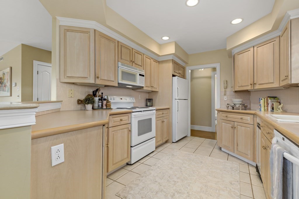 105 Parker Road, Unit A Barnstable, MA 02655 - Photo 8 of 37 a kitchen with white cabinets and white appliances
