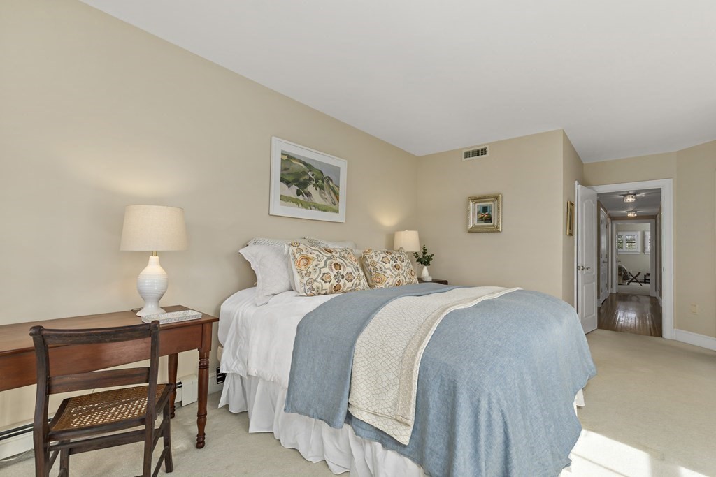 105 Parker Road, Unit A Barnstable, MA 02655 - Photo 10 of 37 a bedroom with a bed and a lamp on table