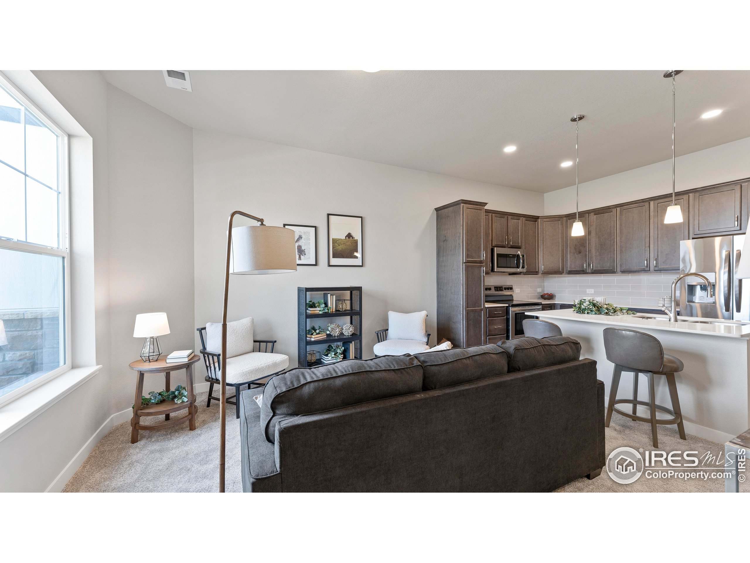 6780 Maple Leaf Drive Timnath, CO 80547 - Photo 13 of 26 a living room with furniture and a large window