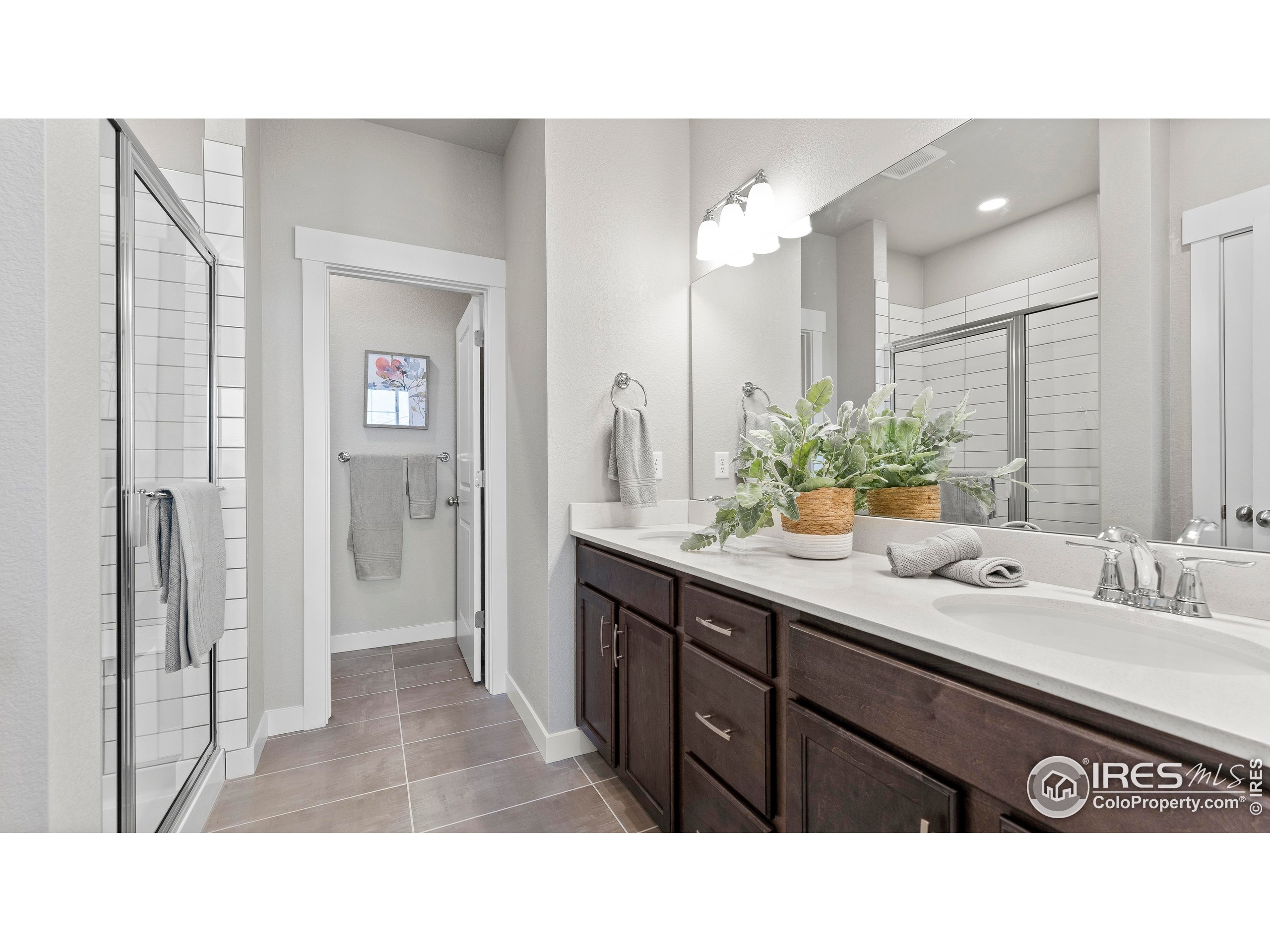 6780 Maple Leaf Drive Timnath, CO 80547 - Photo 19 of 26 a bathroom with a sink double vanity and a mirror