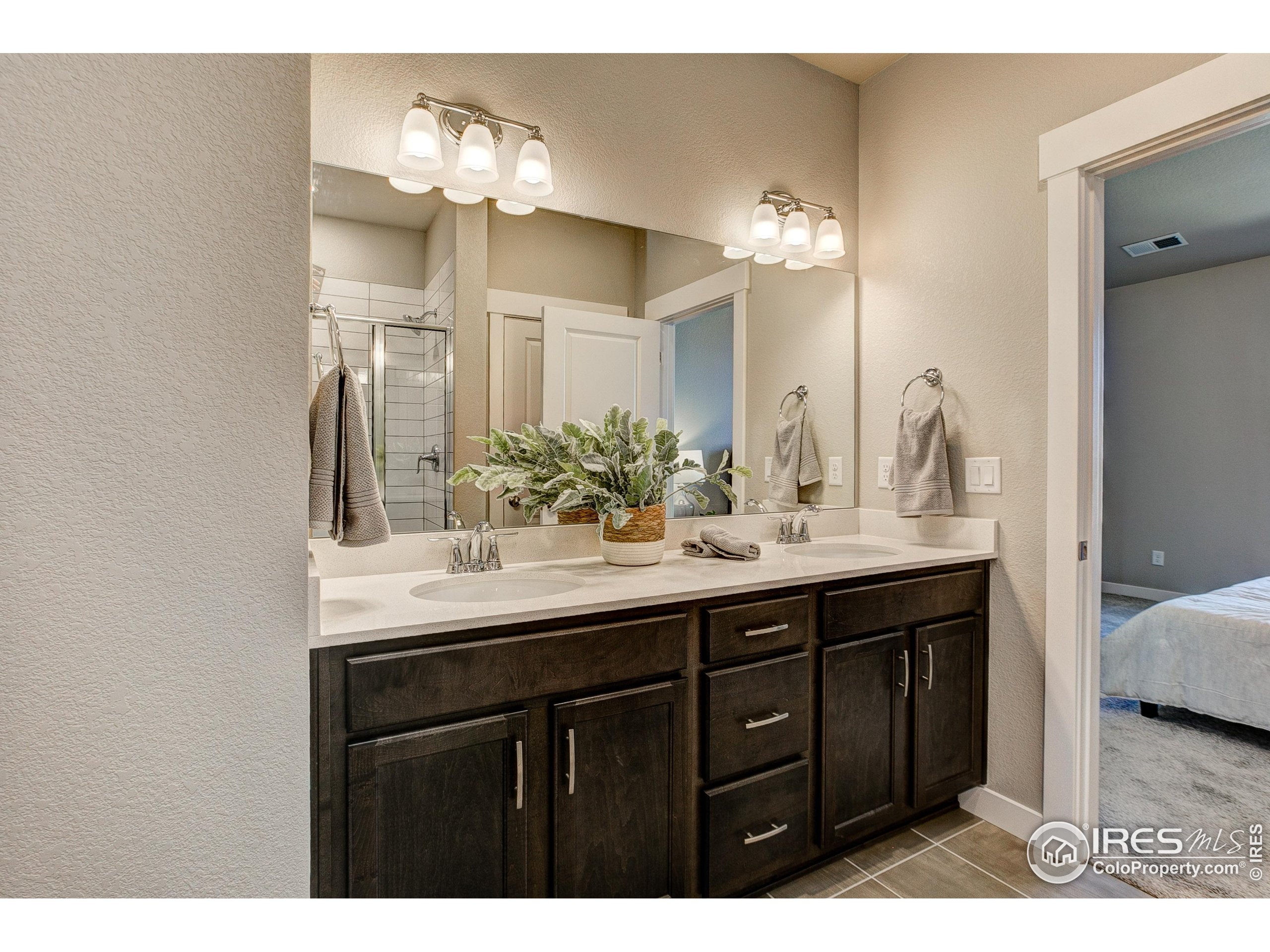 6780 Maple Leaf Drive Timnath, CO 80547 - Photo 20 of 26 a bathroom with a sink double vanity and a mirror